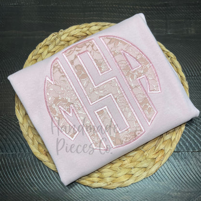 Folded pink sweatshirt with lace monogram