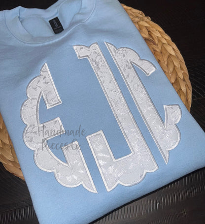 Light blue sweatshirt with white lace monogram